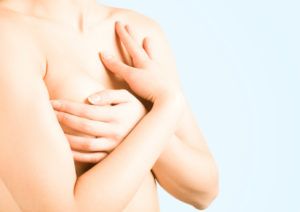 Beautiful female torso against light background